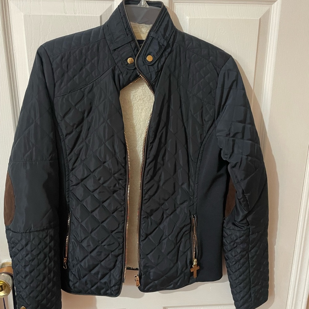 Wool lined jacket with gold detailing in zipper and pockets.